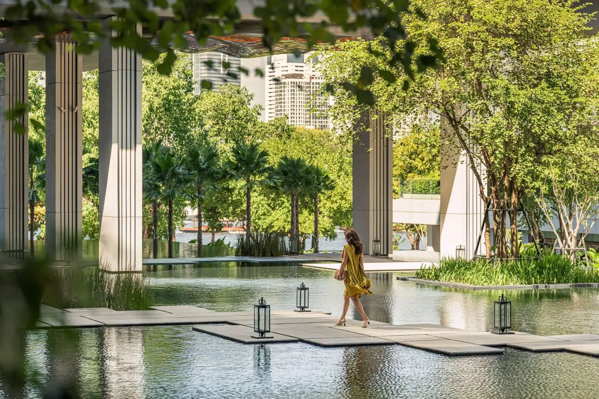A private waterside walkway framed by palms, set for an evening journey